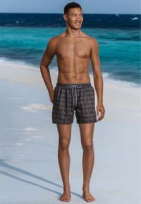 Men's swim trunks in dark gray with a geometric pattern. Lightweight fabric, elastic waistband with drawstring, above-the-knee length.