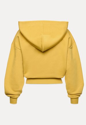 Żółta, krótkia bluza z dużym kapturem, szerokimi rękawami i ściągaczami; wykonana z miękkiego, teksturowanego materiału; prosty i minimalistyczny design.