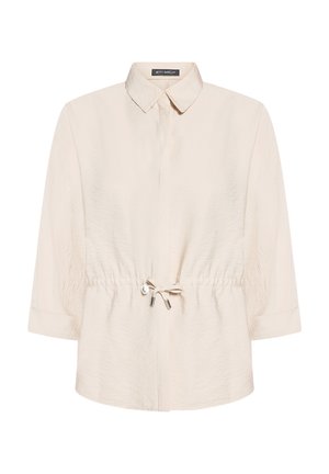 Veste longue à manches longues beige clair avec un col pointu et une taille ajustable par cordon, dotée d'une fermeture avant dissimulée.