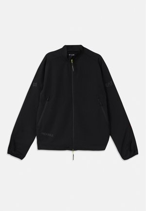 Black packable jacket made of lightweight material, featuring zippered front, side pockets, and logo accents in gray and green.