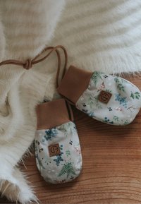 Kukkakuvioiset kangashanskat, joissa on ruskea resorikampas ja logopläntti sekä säädettävä kiristysnauha. Pehmeä rakenne.