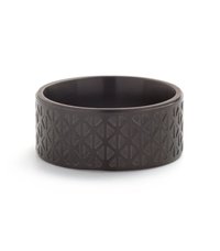Black ring made of textured material featuring a geometric pattern of triangles and diamonds around the band. Smooth inner surface.
