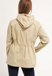 Ljusbeige, huva jacka med elastisk midja, med långa ärmar och avslappnad passform. Slät textur och enkel design.