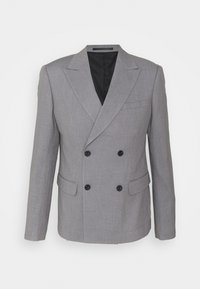 Blazer gris à double boutonnage en tissu texturé. Comprend un col structuré, deux poches avant et une doublure intérieure noire. Détails en boutons noirs.