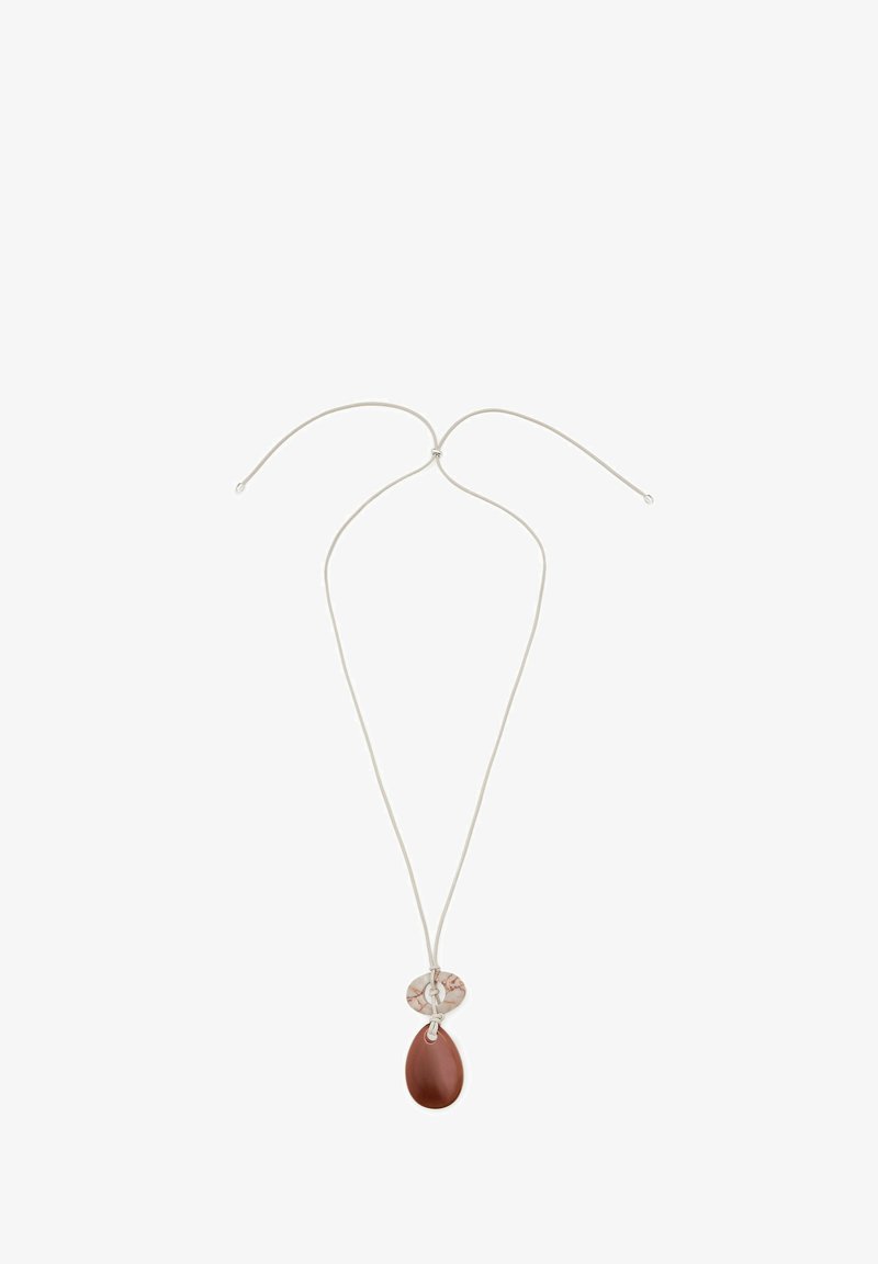 Brown teardrop pendant on a thin silver cord, featuring a round, patterned accent piece above the pendant. Smooth texture, minimalist design.