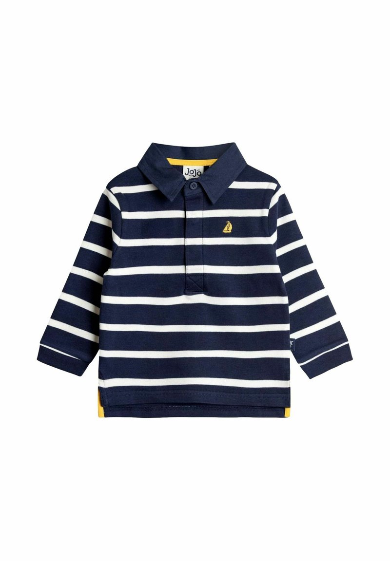 Tengerészkék és fehér csíkos, hosszú ujjú pólóing, amelynek gallérja van és sárga díszítéssel rendelkezik az alján. A mellkasán egy kis vitorlás hajó logó található.