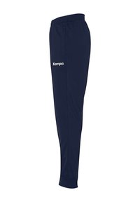 Marineblå sportsbukser med elastisk taljebånd, der har en lynlåslomme og "Kempa"-logo i hvid på venstre side. Glat tekstur.