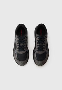Black and gray athletic shoes featuring mesh and leather materials, round toe, laces, and a textured sole with logo detail.