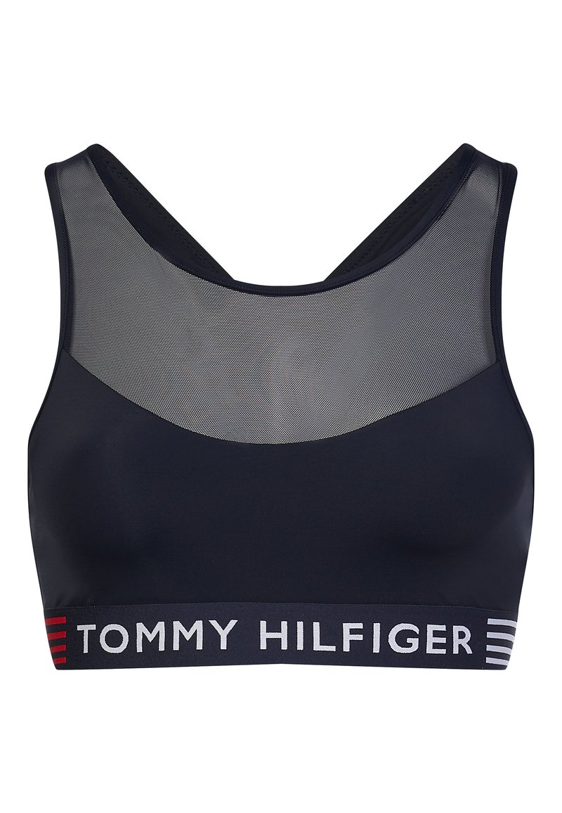 Sujeción deportiva en color azul marino con sección superior de malla, tirantes anchos y banda elástica con la marca que presenta "TOMMY HILFIGER" en detalles blancos y rojos.