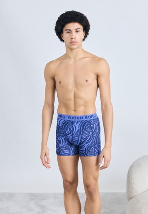 Blue patterned boxer shorts with a fitted design, featuring a dark leaf motif. Elastic waistband displays the brand name "BJÖRN BORG."