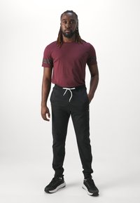 Champion ICON PANTS - Tepláky - black
