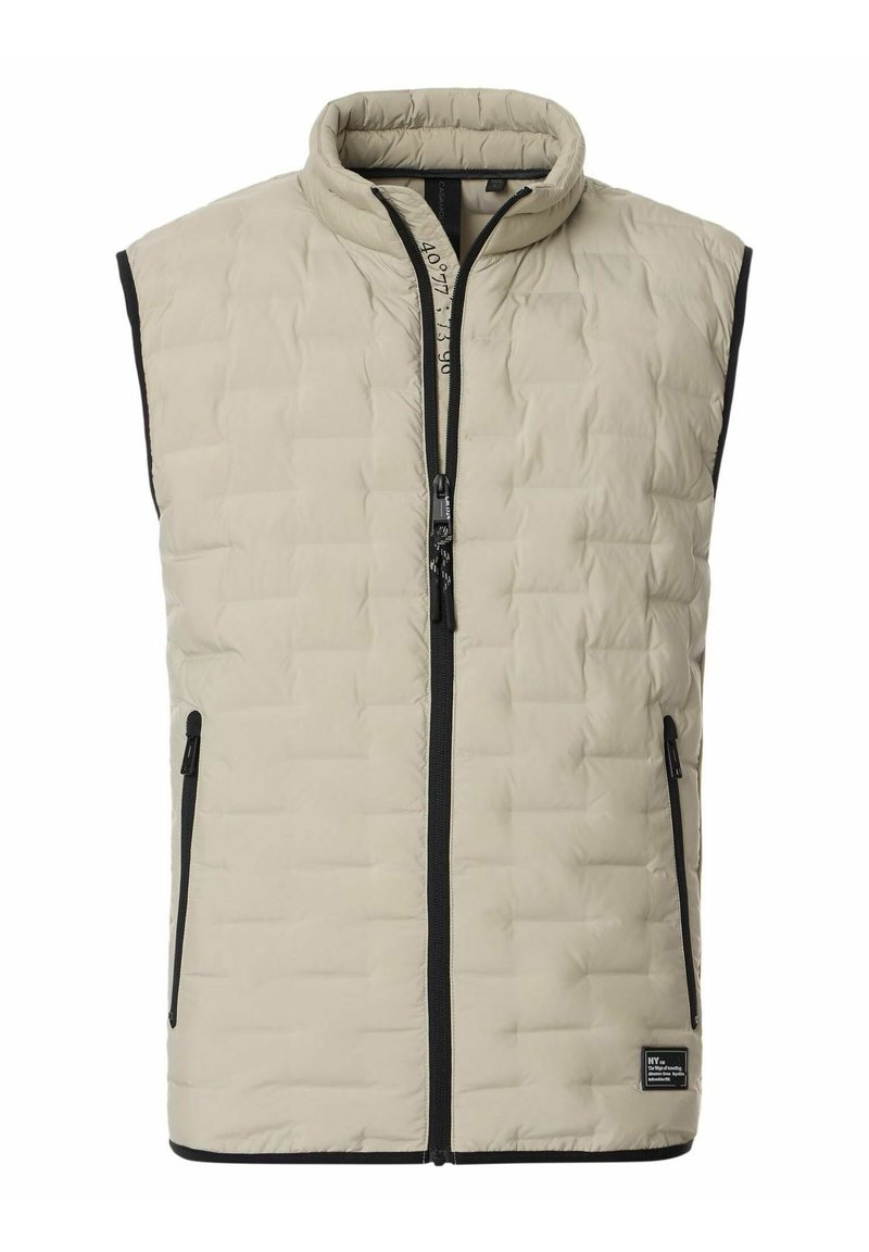Beige gesteppte Weste mit hohem Kragen, Frontreißverschluss und schwarzen Akzenten. Verfügt über Seitentaschen und eine weiche, gepolsterte Textur.