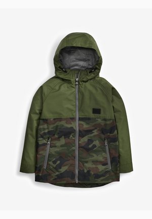 Veste de camouflage avec capuche, présentant un mélange de motifs vert foncé et marron, poches zippées et une texture lisse. Matériau résistant à l'eau.