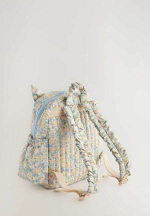 Quilted fabric backpack in pastel colors with floral pattern, ruffled straps, cat-ear accents, and a zip closure. Features side pockets.
