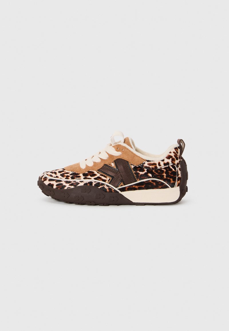Brown and cream sneaker with a leopard print design, suede material, a thick patterned sole, and a lace-up front.