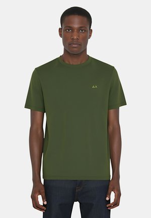 Maglietta verde a maniche corte con collo rotondo, realizzata in tessuto morbido, con un piccolo logo giallo sul petto e un design semplice.