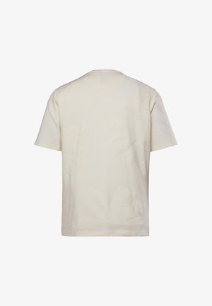 T-shirt in cotone crema con maniche corte, caratterizzato da un sottile motivo testurizzato che ricorda le foglie di palma, scollatura rotonda e vestibilità standard.