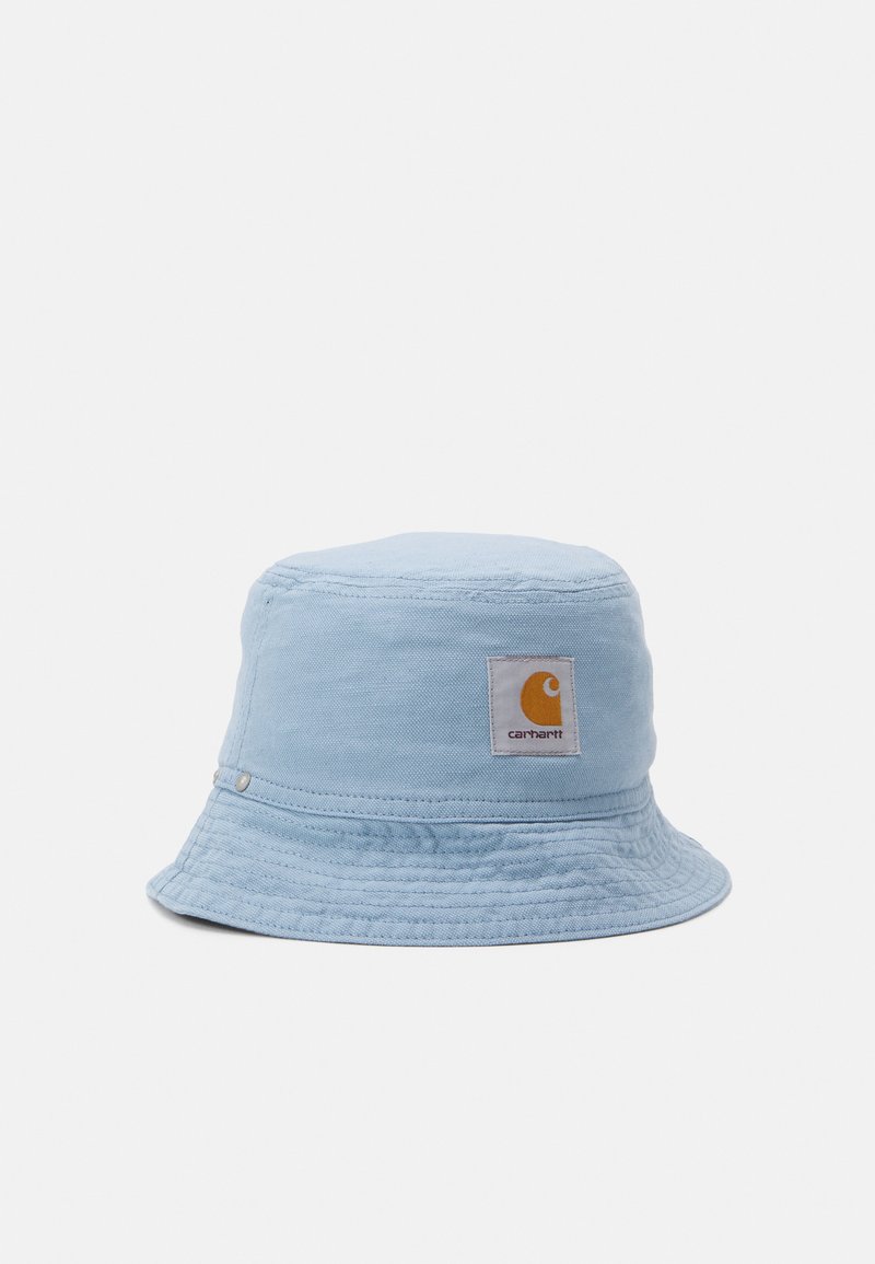Light blue bucket hat made of cotton with a soft texture, featuring a white label with an orange logo and subtle metallic hardware accents.