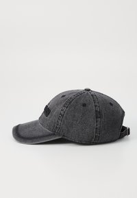 Gray denim baseball cap with a curved brim, six panels, and adjustable strap. Features stitched accents and a logo on the front.