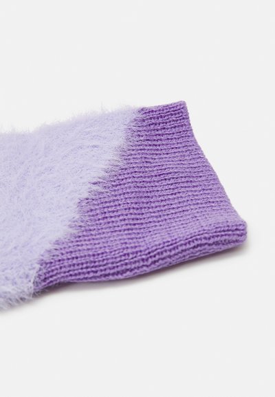 Purple knitted sock featuring a fluffy texture on one side, transitioning from fuzzy to a smooth, ribbed knit.