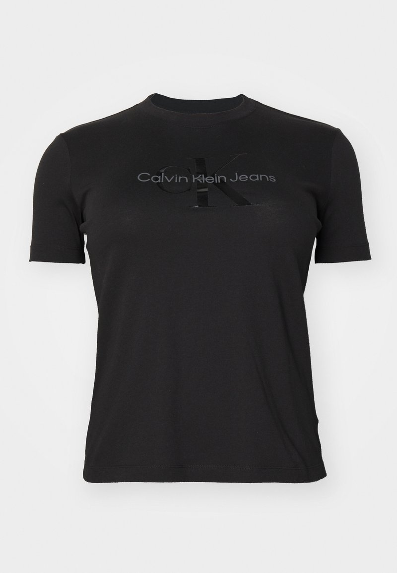 Melns īsām piedurknēm T-krekls, izgatavots no kokvilnas. Uz krūtīm ir spīdīga "CK" logo un diskrēta "Calvin Klein Jeans" uzraksta apdruka.
