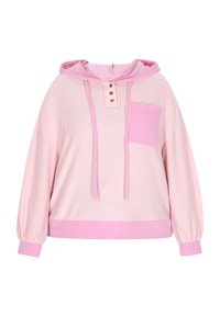Růžová oversize mikina s ribovanou textrurou, s patkami na knoflíky, klokaní kapsou a proužkovými akcenty na kapuci a manžetách.