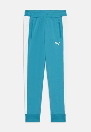 Teal athletic pants with elastic waistband, two zippered pockets, and white side panels. Features a white Puma logo on the thigh.