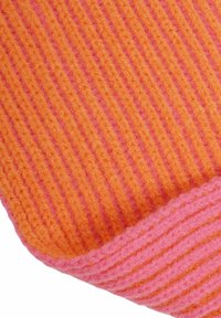 Knit blanket featuring alternating orange and pink stripes. Textured, soft yarn with a ribbed design. Colorful and cozy appearance.