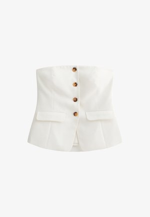 Vit axelbandslös topp med ett figursytt design, fem glansiga bruna knappar och två sidofickor. Slät tyg med en strukturerad silhuett.