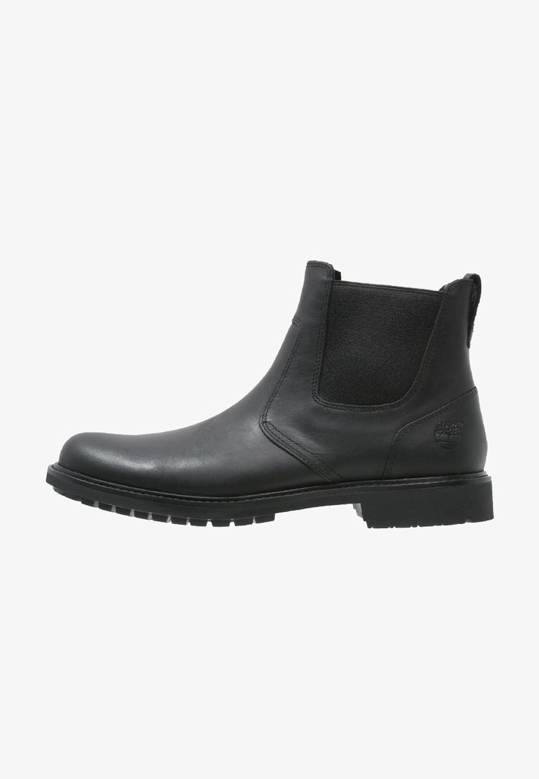 Bottine Chelsea en cuir noir avec un panneau latéral élastique et une semelle en caoutchouc robuste, avec un petit logo embossé sur le talon.