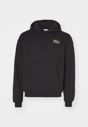 Schwarzer Hoodie aus Baumwollmischung, mit Kängurutasche, langen Ärmeln und einem grünen Krokodil-Logo auf der linken Brust.