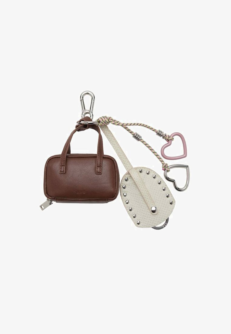 Mini sac à main en cuir marron et porte-clé en cuir blanc clouté attaché à un mousqueton avec deux breloques en métal en forme de cœur.