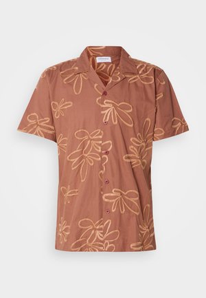 Brown short-sleeve shirt featuring a floral pattern in gold thread, with two dark buttons and a collar. Soft fabric with a relaxed fit.
