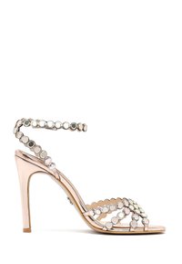 Rose gold high-heeled sandal with ankle strap and multiple straps adorned with reflective circular embellishments.