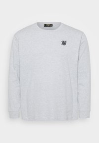 Grå langermet T-skjorte laget av myk bomull, med rund halsringning og en liten svart logo brodert på venstre bryst.
