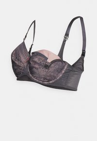 Reggiseno con sovrapposizione in pizzo nero, fodera rosa chiaro, supporto con ferretto e spalline regolabili con dettagli decorativi e chiusura a tre ganci.