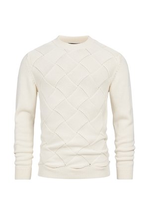 Suéter de punto color crema con un patrón de diamantes, puños y dobladillo acanalados. Fabricado con un material suave y con un cuello redondo.