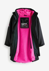 Fekete, szigetelt dzseki puha rózsaszín cipzáras béleléssel. Cipzáras záródással és a "SUPERDRY JPN" felirattal ellátott látható címkével rendelkezik.