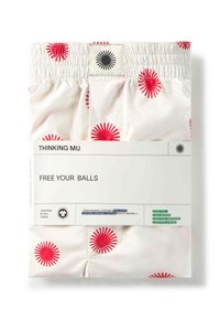 Laatua orgaanisesta kermamaalatusta puuvillasta valmistetut bokserit, joissa on punaisia auringonsädekuvioita. Joustava vyötärö, jossa on merkki ja tuotetiedot sisältävä etiketti.