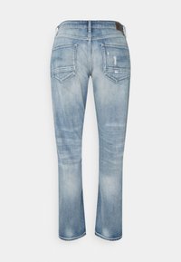 Ljusblå denimjeans med avslappnad passform, som har framträdande bakfickor och subtil slitage. Slät textur, rak ben-design.