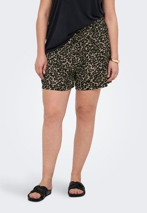 Shorts en imprimé léopard avec taille élastique, tissu léger et coupe décontractée, associés à des sandales à glissière noires.