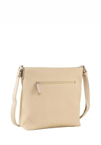 Beżowa torebka na ramię wykonana z teksturowanej tkaniny. Posiada przednią kieszeń zapinaną na zamek, regulowany pasek oraz minimalistyczny design.