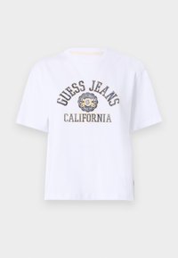 Bílá bavlněná tričko s krátkým rukávem, s potiskem "GUESS JEANS CALIFORNIA" v tmavě modré a zlaté barvě. Kulatý výstřih, uvolněný střih.