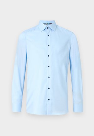 Light blue button-up shirt made of smooth fabric. Features a classic collar, long sleeves, and dark buttons on the front placket.