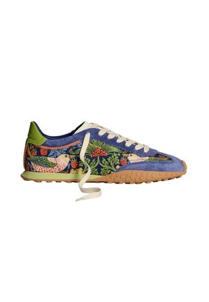 Suede sneaker featuring a blue body with floral patterns, green accents, beige laces, and a textured gum rubber sole.