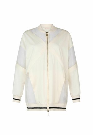 Cream bomber jacket with sheer panels, contrasting black stripes at the cuffs and hem, a zip front closure, and a stand-up collar.