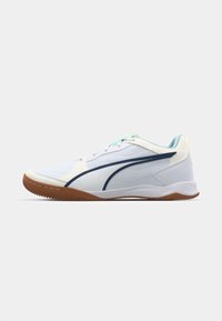White athletic shoe with blue accents, a sleek design, and a textured gum sole. Features include laces and a reinforced heel.