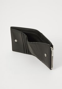 Black leather wallet with multiple card slots, a zippered compartment, and a snap closure. Features a smooth texture and minimalist design.