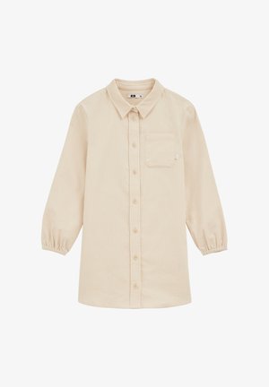 Gai bēšs kordūrīna krekls ar garām, elastīgām piedurknēm, apkakli, pogu aizdari un vienu krūšu kabatu. Mīksta tekstūra ar ribotu rakstu.