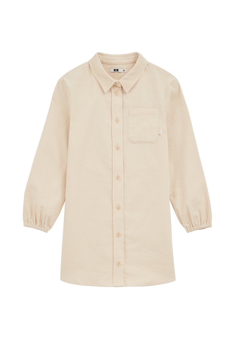 Camicia in corduroy color beige chiaro con maniche lunghe elasticizzate, colletto, chiusura con bottoni e una tasca sul petto. Texture morbida con motivo a coste.